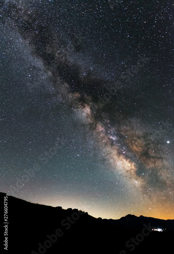 Beautiful night landscape. Starry night and bright milky way galaxy over the hills.