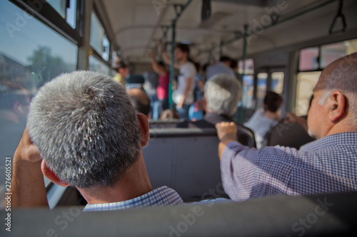 İs the main mass transit passengers in the bus. People in old public bus, view from inside the bus . People sitting on a comfortable bus in Selective focus and blurred background.