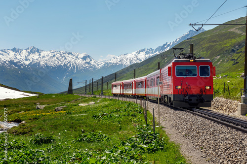Swiss alpine railway train. swiss mountain train. summer and snow