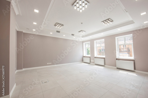 apartment interior reception unfurnished with wide windows and tiled floor  the interior is in gray tones