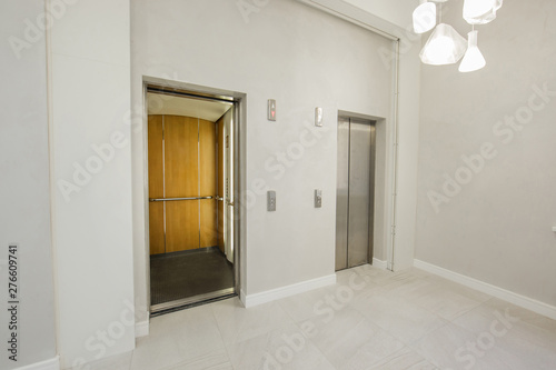 Modern steel elevator cabins in the business lounge or hotel, shop, salon, office, widescreen in perspective.