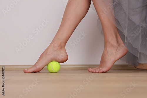 Flat Feet Correction exercises with a ball . Woman massaging her feet. Posture correction, Physical therapy. photo