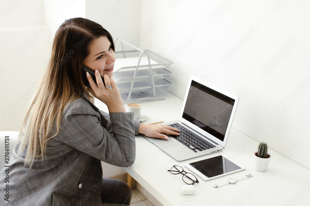 younger girl working in the office at the table younger girl working in the office at the table
