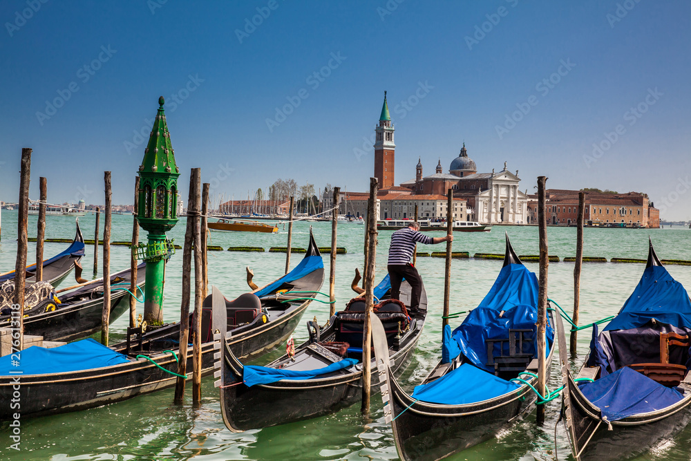 Traditional Venetian gondolas at the Grand Canal in front of the beautiful Basilica Di San Giorgio Maggiore