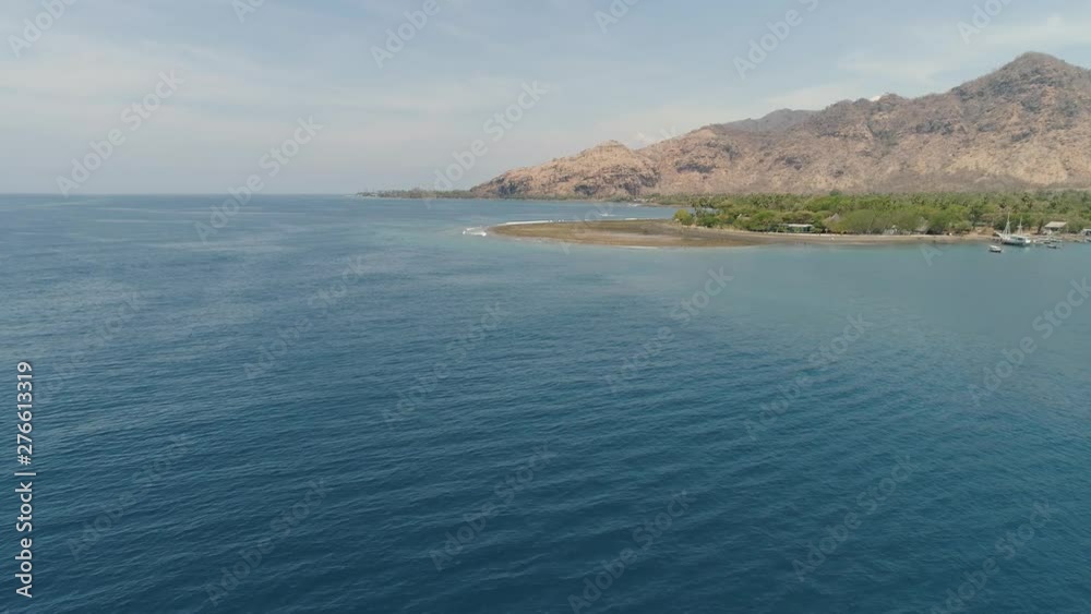 aerial tropical landscape town by sea, mountains, beach, boats on surface water. Bali,Indonesia, travel concept. aerial footage aerial tropical landscape town by sea, mountains, beach, boats on surface water. Bali,Indonesia, travel concept. aerial footage