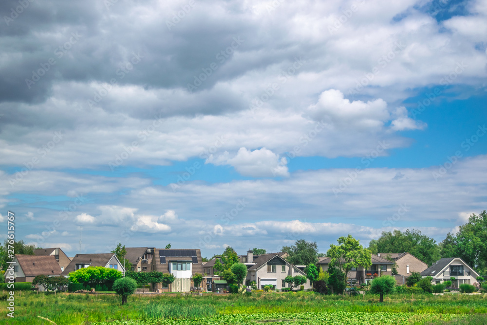 Traditional Dutch village Ooij protected by a dike to prevent flooding by the river Waal, Netherlands