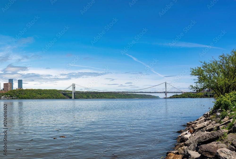 The George Washington Bridge, GWB, connecting Upper Manhattan and New Jersey, with the Hudson River in the foreground