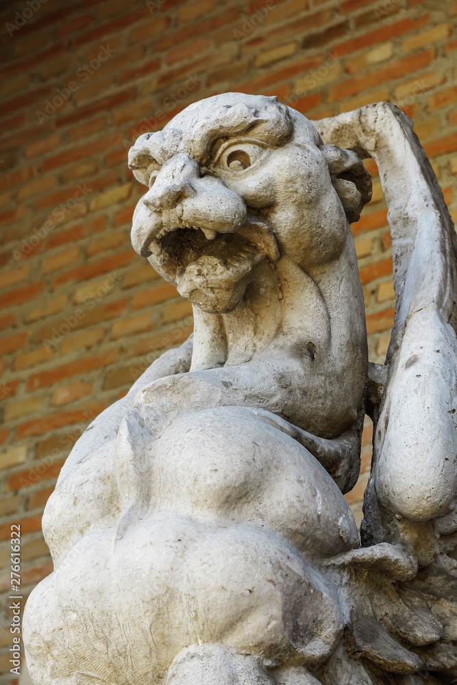 Fototapeta premium detail in foreground of an ancient gargoyle carved in stone
