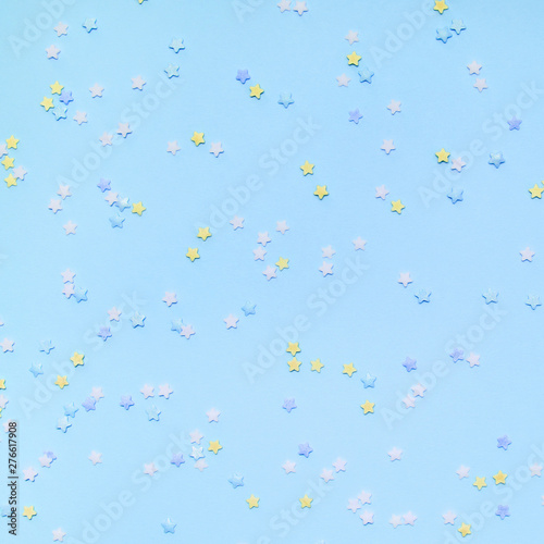 Little stars confetti on blue background. Holyday concept.