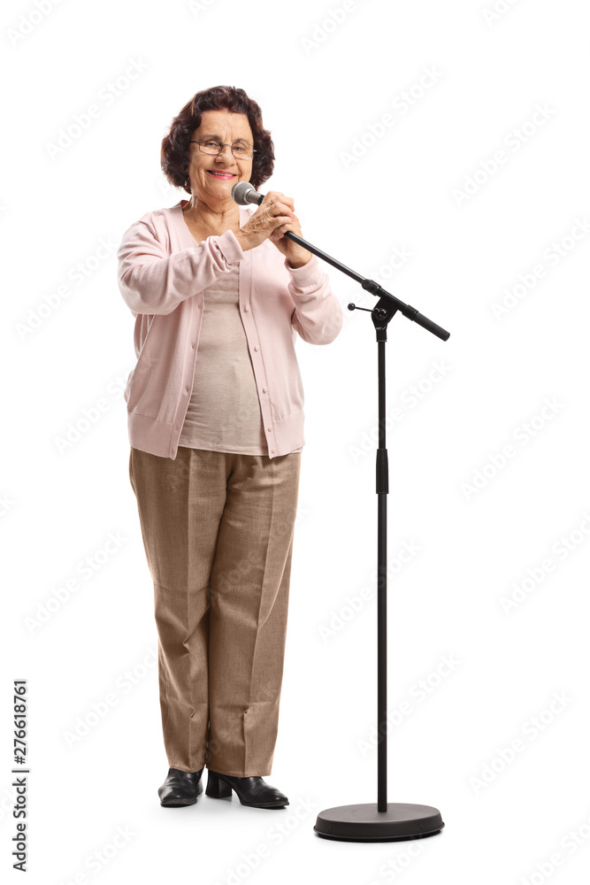 Elderly woman standing in front of a microphone on a stand