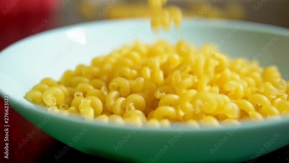 raw pasta. kawatappi pasta falls in a blue dish raw pasta. kawatappi pasta falls in a blue dish
