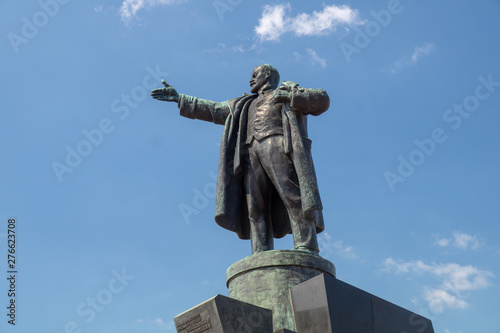 Lenin monument close up against the blue sky on a sunny summer day