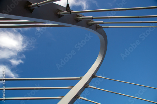 cable-stayed bridge against the blue cloudy sky close-up on a sunny summer day © Ilya Kaifat