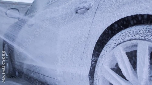 the car is poured foam on the sink.slow motion video of washing