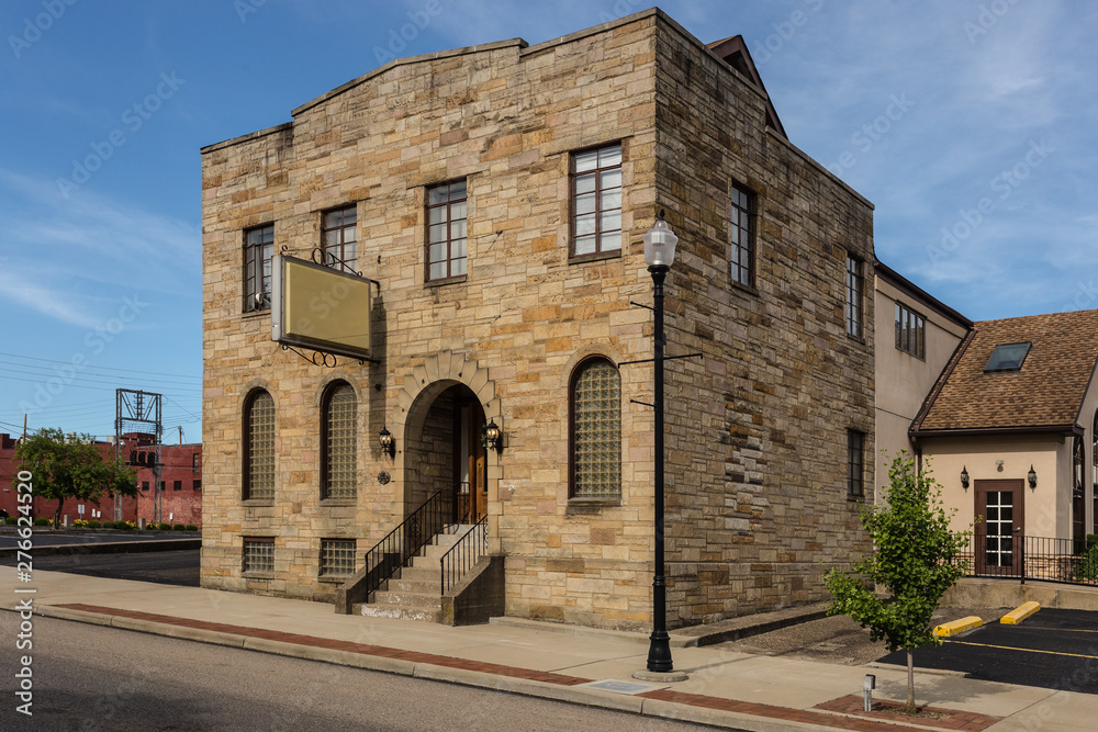 Two story large brick building with signage on front in a small midwestern town Two story large brick building with signage on front in a small midwestern town