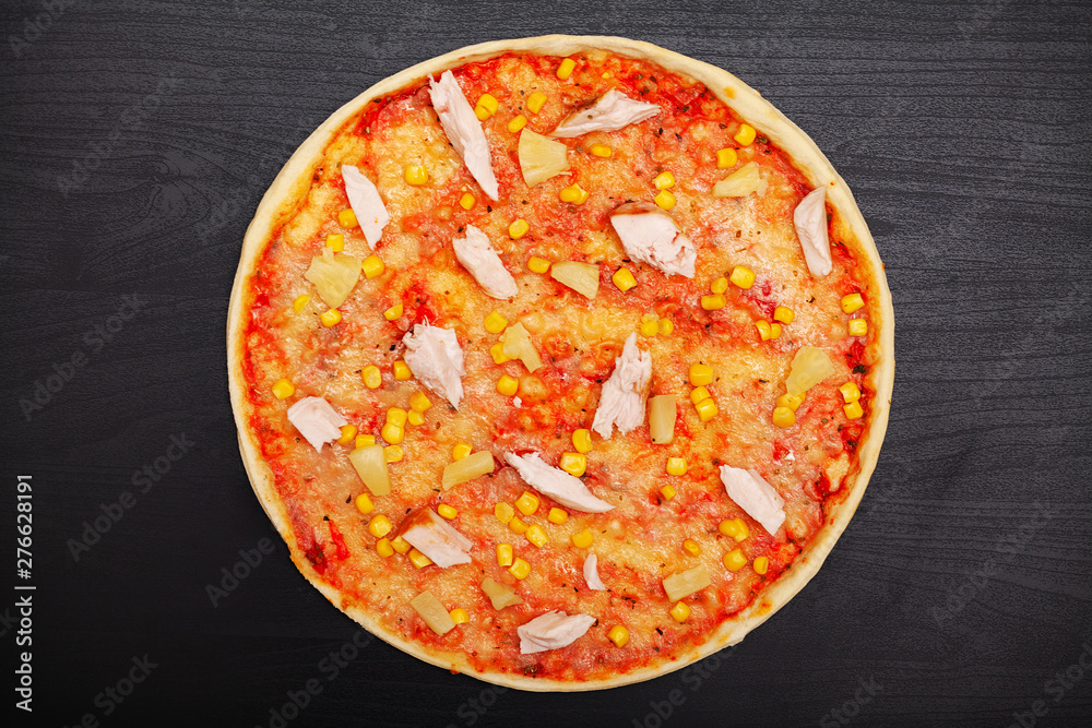 Tasty pizza with various flavored ingredients on a dark background Tasty pizza with various flavored ingredients on a dark background