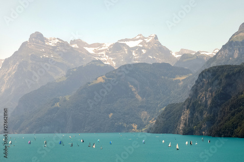 yachts in rocks mountains and snow. Sailboat in the lake on the background Mountains and snow
