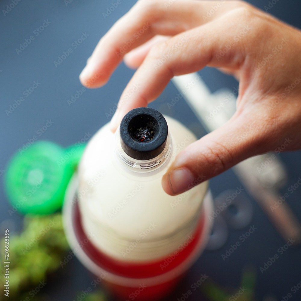Smoking weed through the bottle. Cannabis use through homemade bong Smoking weed through the bottle. Cannabis use through homemade bong