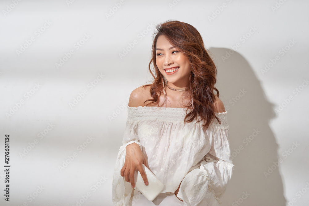 pretty asian woman in casual wear holding smartphone in one hand, dancing pretty asian woman in casual wear holding smartphone in one hand, dancing