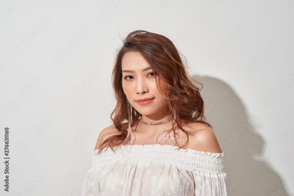 Gorgeous young model. Close up of an attractive girl of Asian appearance on white background Gorgeous young model. Close up of an attractive girl of Asian appearance on white background