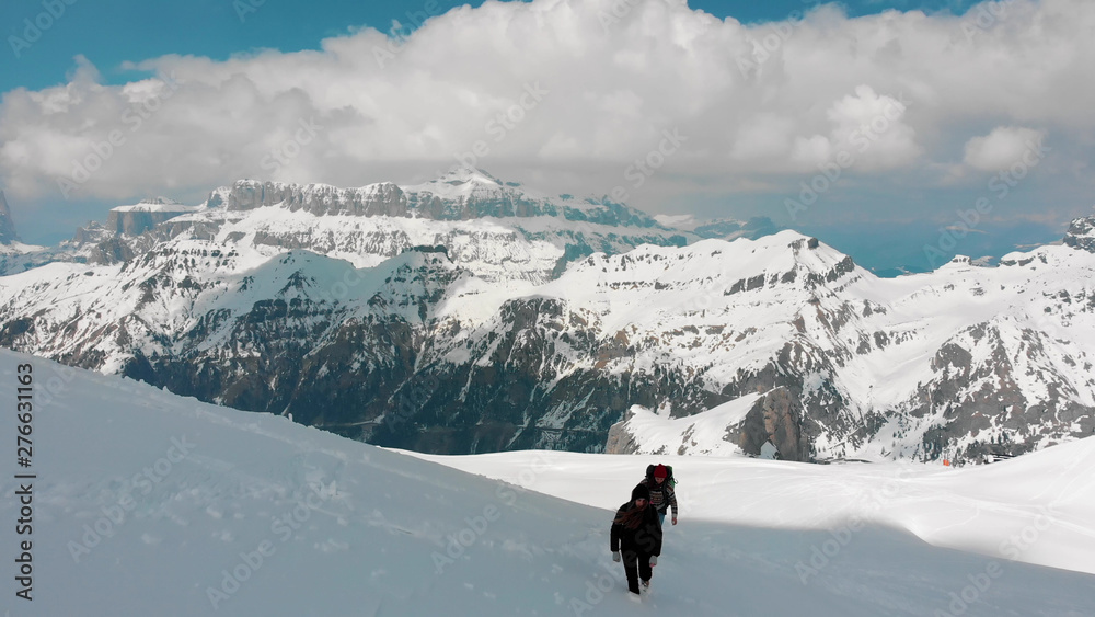 Two traveling women walking upwards on the mountain - Dolomites, Italy