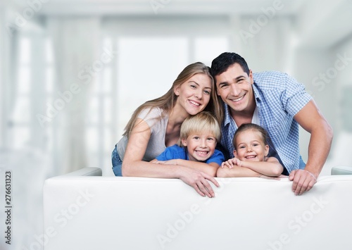 Beautiful smiling family in room on couch