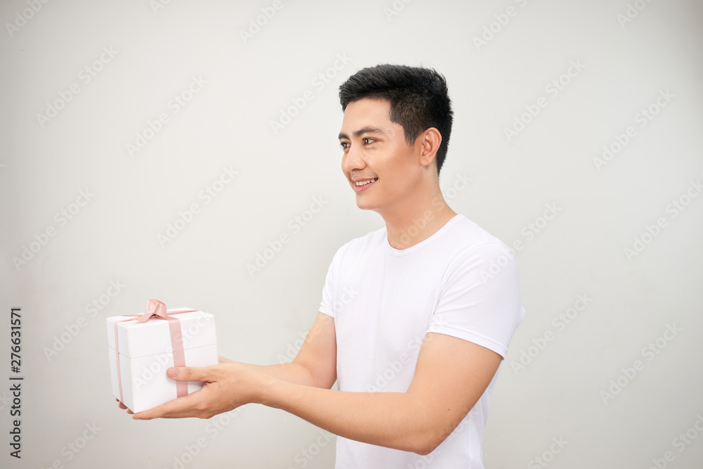 A happy handsome man presenting some gifts. Isolated on white background. A happy handsome man presenting some gifts. Isolated on white background.