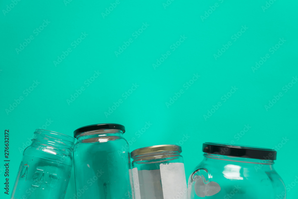 Isolated glass jars, flat on teal mint green background, room for copy space top Isolated glass jars, flat on teal mint green background, room for copy space top