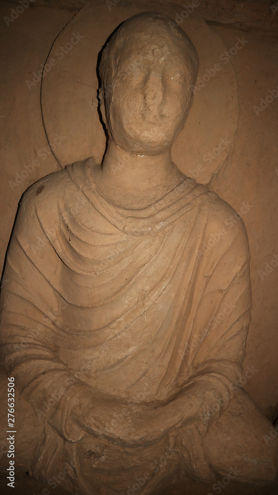 Statue of the Buddha at Jaulian ruined Buddhist monastery, Haripur, near Taxila, Pakistan. A UNESCO World Heritage Site, dating from the second century CE. - obrazy, fototapety, plakaty 