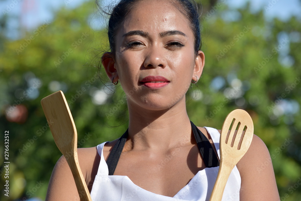 Unemotional Female Cook Chef With Utensils Unemotional Female Cook Chef With Utensils