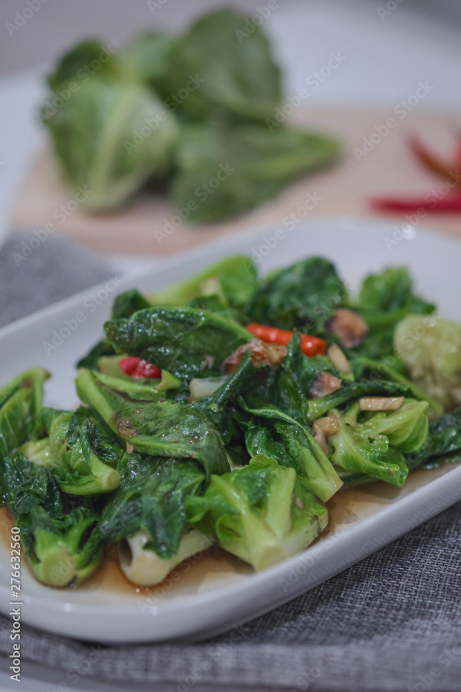 Stir-fried Brussels sprout with sun-dried crispy fish on the plate. Stir-fried Brussels sprout with sun-dried crispy fish on the plate.