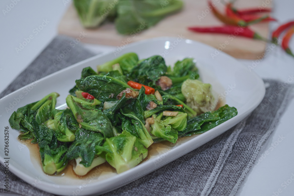 Stir-fried Brussels sprout with sun-dried crispy fish on the plate. Stir-fried Brussels sprout with sun-dried crispy fish on the plate.
