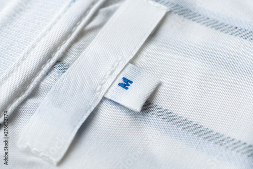 Blank white clothes label on new shirt