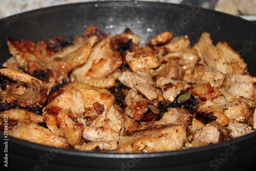 fried with onions meat from pork in a frying pan