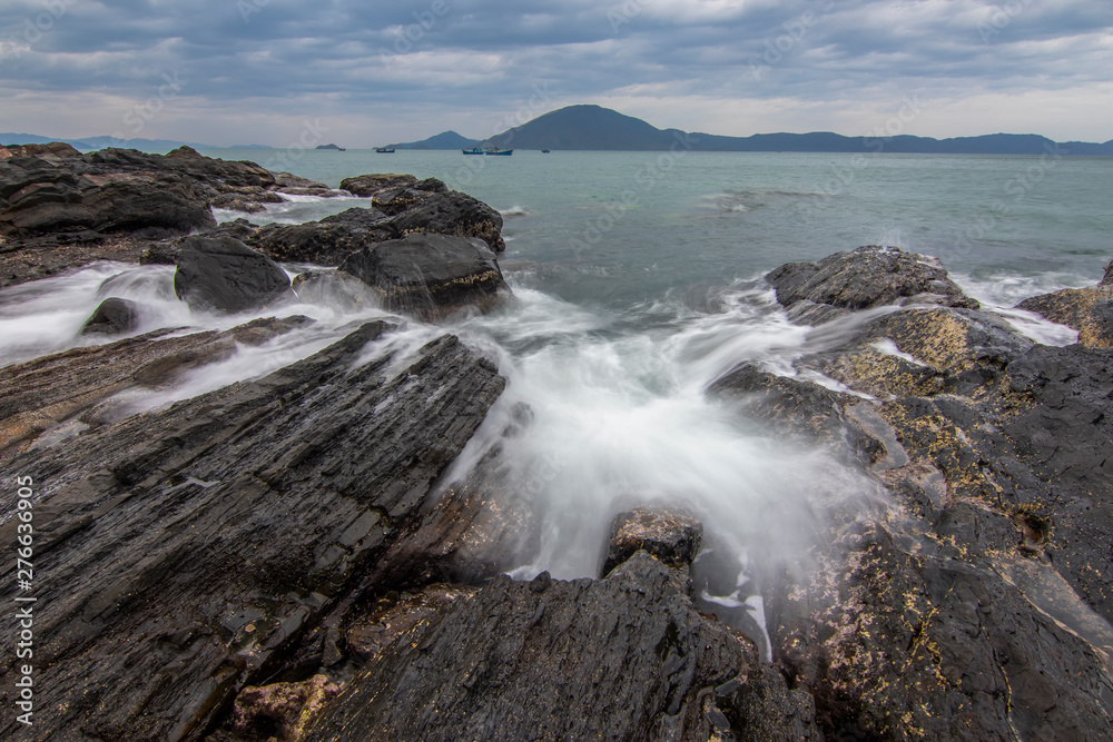 Sea dawn with waves and rocks at nha trang