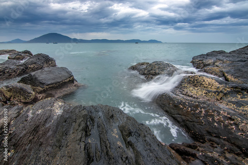 Sea dawn with waves and rocks at nha trang