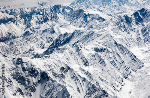 Aerial view of snowcapped mountian, peak, ridge, valley, cliff and glacier at central Karakoram or Karakorum range in Pakistan, second highest mountain range in the world.