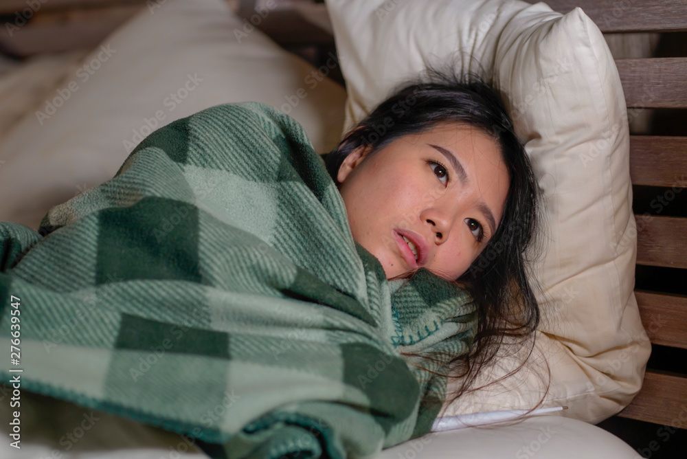 young beautiful sick and exhausted Asian Chinese woman suffering cold and flu having temperature lying on bed covering with blanket feeling ill and unwell awake at night young beautiful sick and exhausted Asian Chinese woman suffering cold and flu having temperature lying on bed covering with blanket feeling ill and unwell awake at night