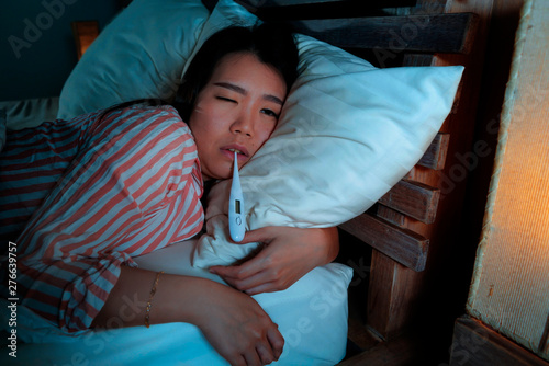 Obraz na plátně young beautiful sick and exhausted Asian Chinese woman suffering cold and flu ta