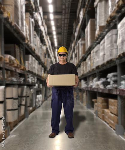 Worker in Mechanic Jumpsuit with holding parcel boxes © sirastock