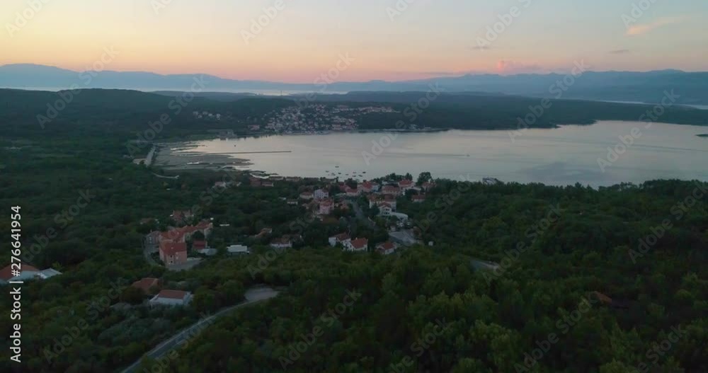 Croatian town at sunset, aerial, rising, drone shot, of buildings and houses, in Soline village, on Krk island, at dusk, on a sunny, summer evening. in Croatia Croatian town at sunset, aerial, rising, drone shot, of buildings and houses, in Soline village, on Krk island, at dusk, on a sunny, summer evening. in Croatia