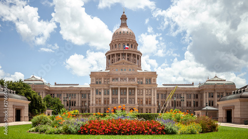 Texas State Capitol in Austin, Texas on a sunny summer day with colorful flowers in the front yard photo