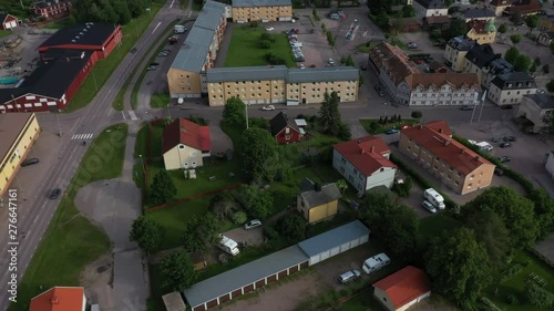 Drone fly over footage showing a residential area with streets, flats and houses in an old mining town while cars are driving by on the main road. Filmed in realtime at 4k. photo