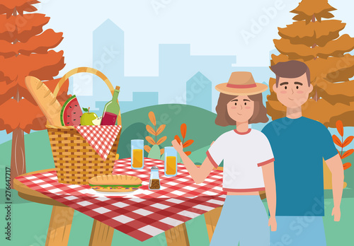 woman and man couple with hamper and food