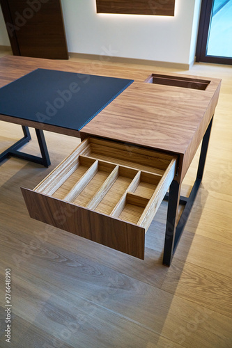 Open drawer of wooden table in office