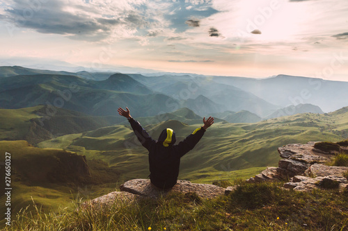 Man Traveler on mountain summit enjoying aerial view hands raised Travel Lifestyle success concept adventure active vacations outdoor happiness freedom emotions
