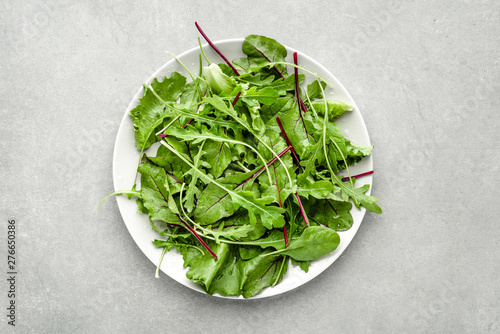 Green salad mix with arugula, spinach and beet leaves. Healthy nutrition. Vegan food concept.