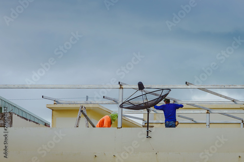 Worker welding the steel part for roof before it is going to rain.