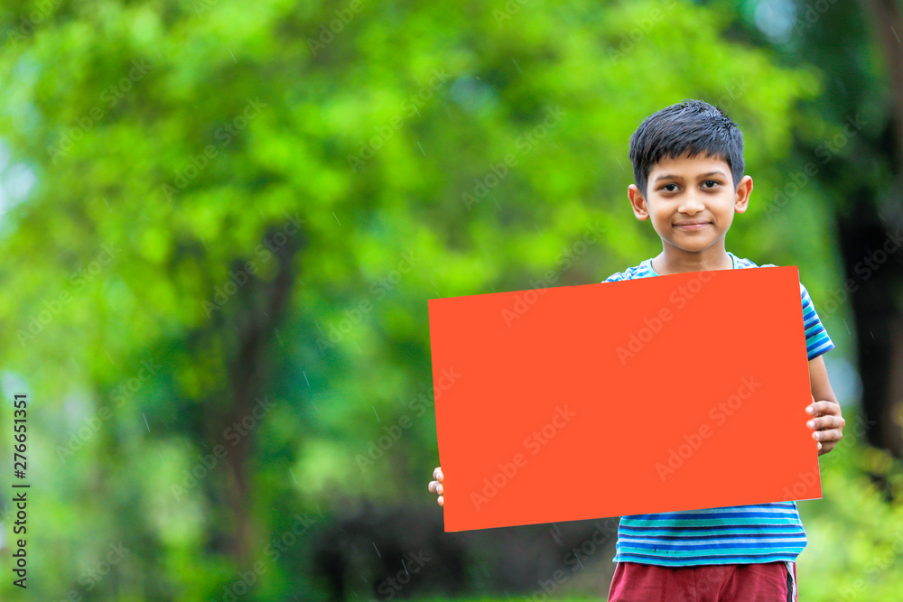 indian child holding empty poster indian child holding empty poster