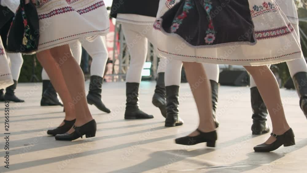 Traditional romanian folklore dancers in traditional costumes dancing ...